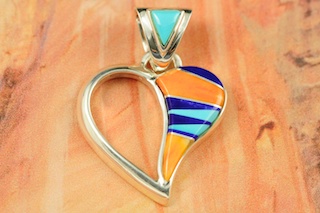 Genuine Turquoise, Spiny Oyster Shell and Blue Lapis inlaid between ribbons of Sterling Silver.  Free 18" Sterling Silver Chain with Purchase of Pendant. Stunning Heart Pendant Designed by Navajo Artist Calvin Begay. Signed.